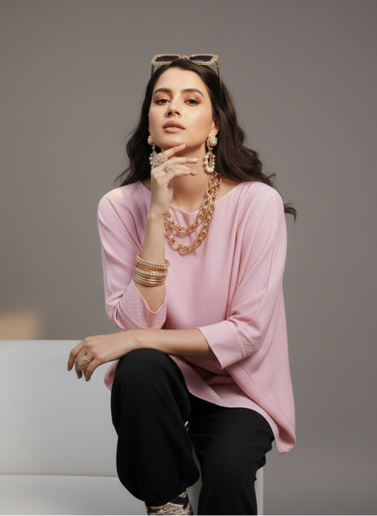Close-up of asymmetrical cut on pink top, soft modern design Moon N Lotus