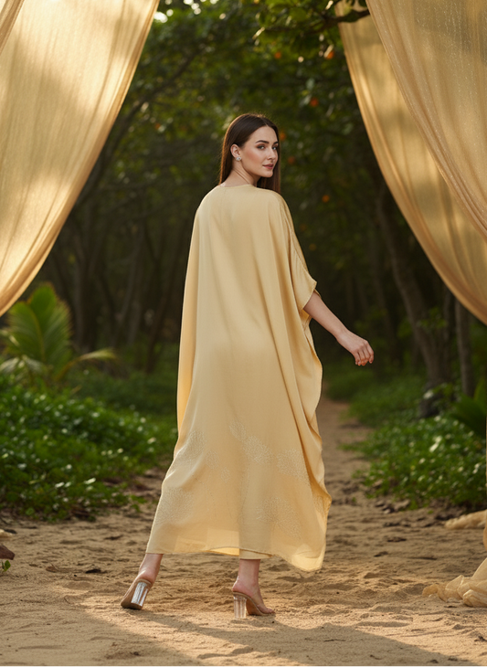 Close-up of floral foil detailing on gold kaftan, elegant subtle shine Moon N Lotus