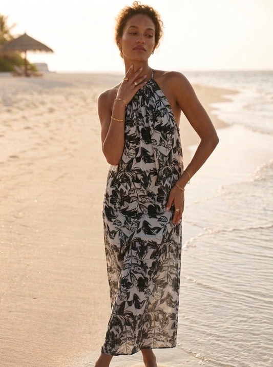 Close-up of black and grey print on orange fabric, long Hawaiian dress detail