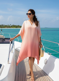 Woman wearing a flowy peach ombre kaftan on a yacht by Moon N Lotus
