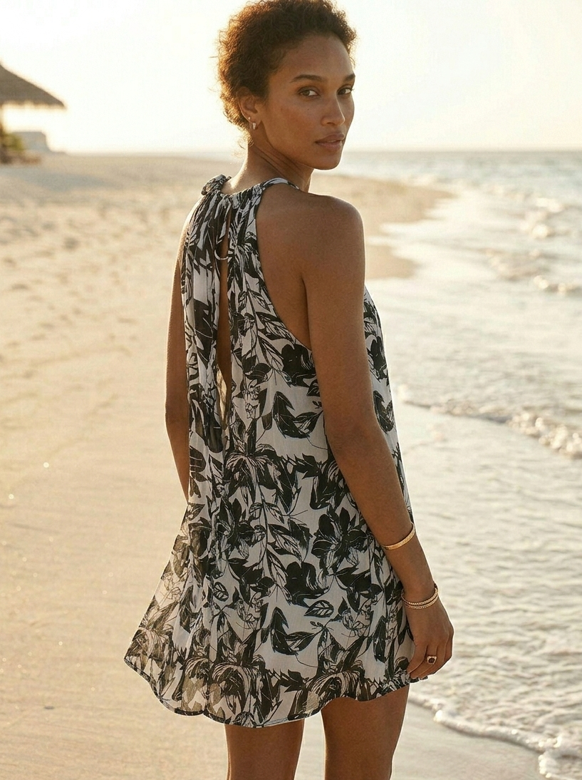 Back view of black short Hawaiian dress in orange fabric, relaxed fit and breezy silhouette Moon N Lotus