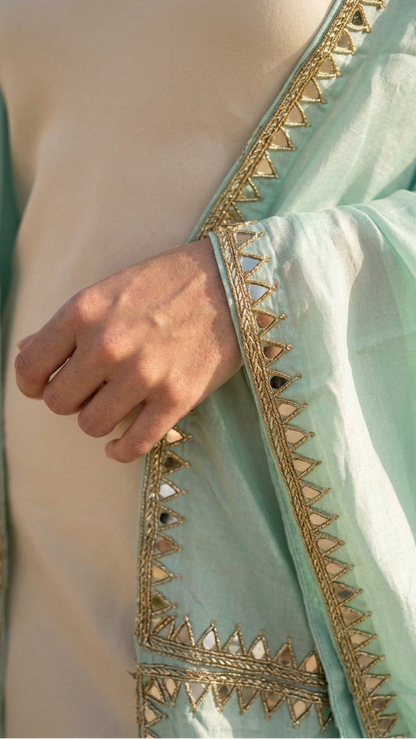 Close-up of embroidery on mint shrug, delicate minimal detailing Moon N Lotus