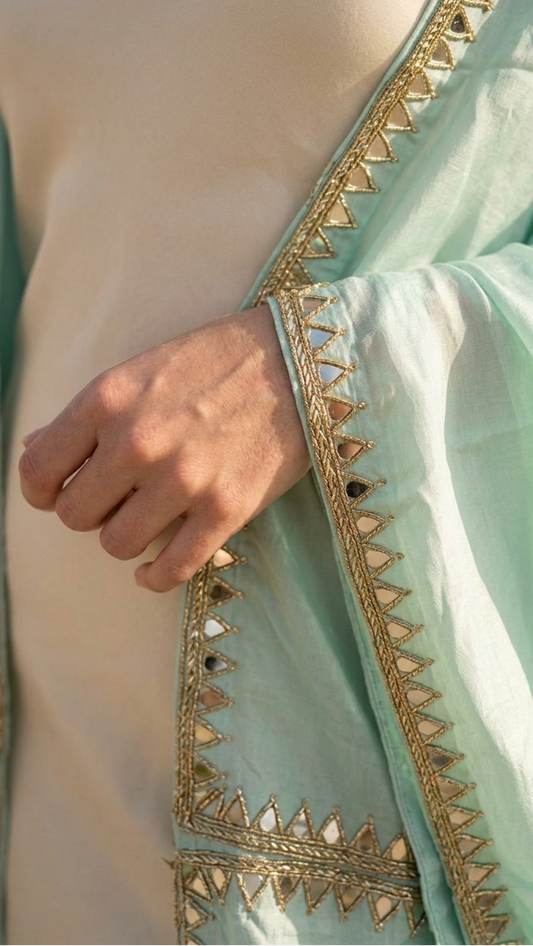 Close-up of embroidery on mint shrug, delicate minimal detailing Moon N Lotus