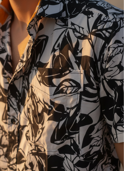 Close-up of black grey print in men’s rose fabric Hawaiian shirt, minimal tropical design