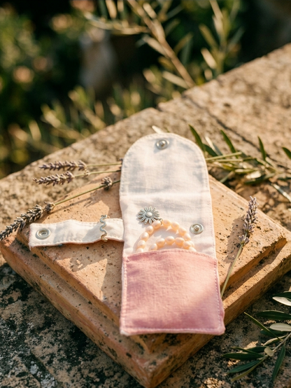 Closed view of compact jewellery pouch in rose fabric, travel friendly Moon N Lotus