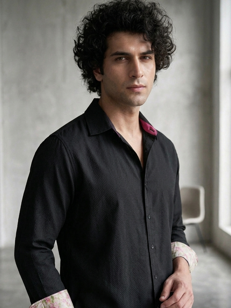 Close-up of orange fabric on black collared shirt, premium breathable design Moon N Lotus