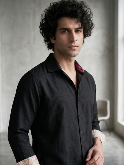 Close-up of orange fabric on black collared shirt, premium breathable design Moon N Lotus