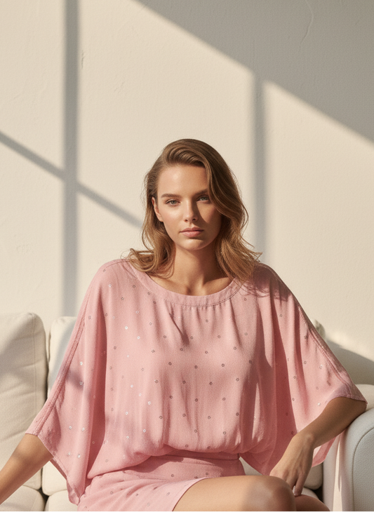 Close-up of polka dot detail on pink circle top, playful minimal design Moon N Lotus