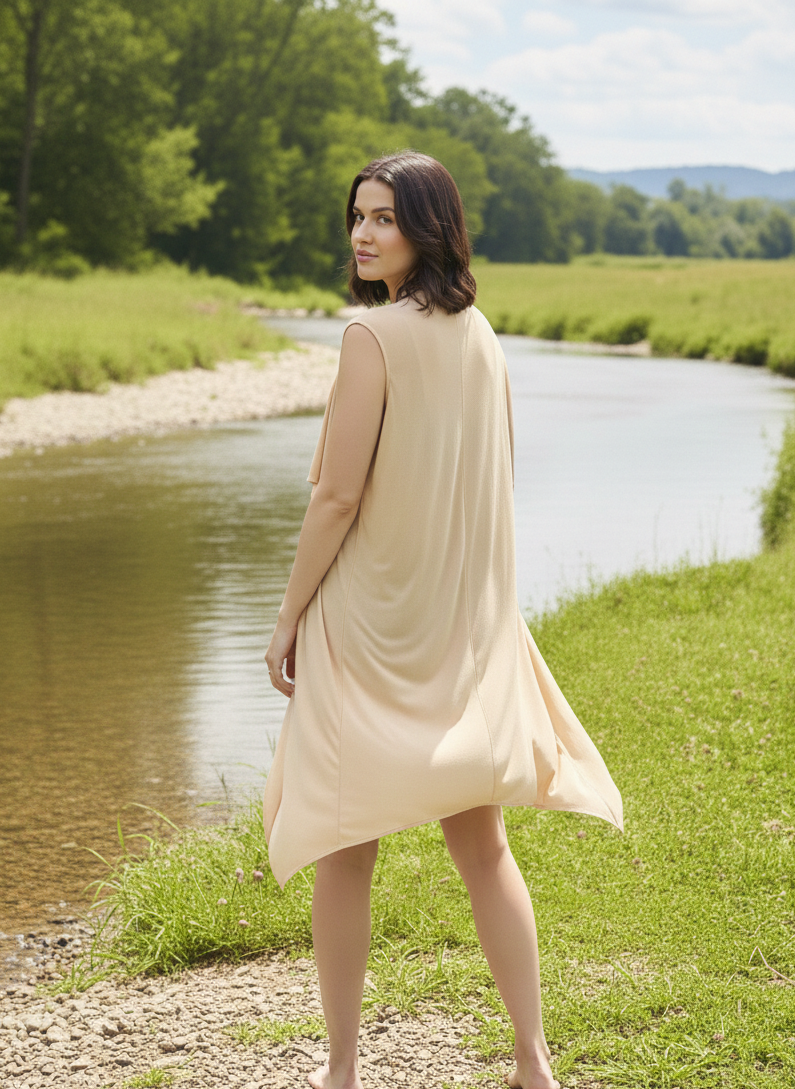 Back view of sleeveless shrug in orange fabric with relaxed silhouette Moon N Lotus